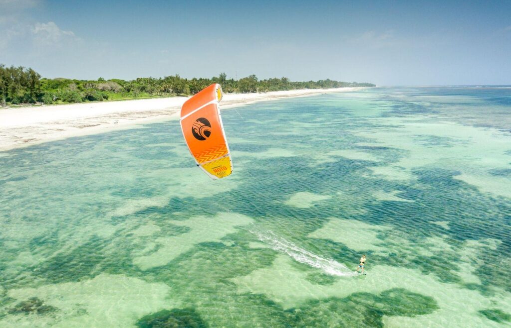 Kitesurfer riding the waves off Diani Beach, Kenya